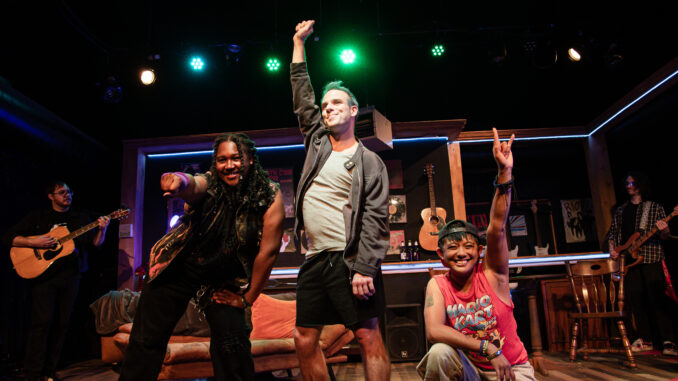 Three people pose at the end of a musical number